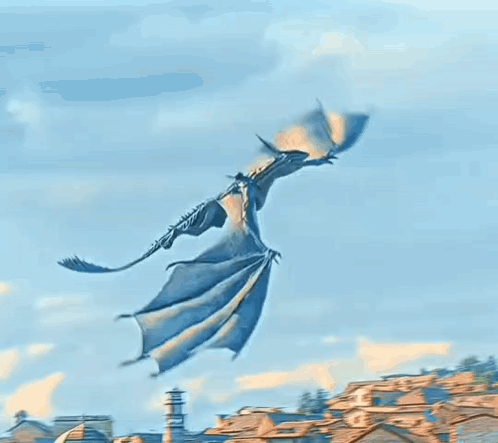 A Dragon Is Flying Over A City With A Building In The Background . GIF