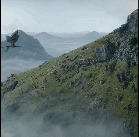 A Dragon Is Flying Over A Mountain Covered In Grass GIF