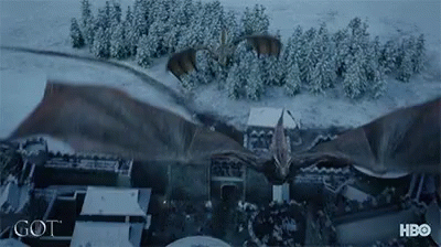 A Dragon Is Flying Over A Snowy City With A Hbo Logo In The Corner GIF