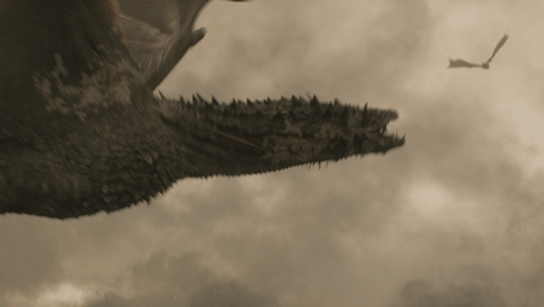 a dragon is flying through a cloudy sky with another dragon flying in the background