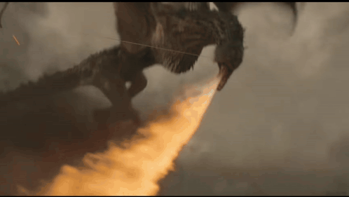 a dragon is flying through the air with a flame coming out of its mouth .
