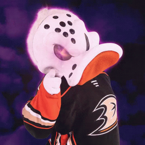A Duck Mascot Is Pointing At Something With His Tongue Out GIF