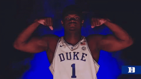 A Duke Basketball Player Flexes His Muscles In The Dark GIF