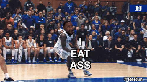 A Duke Basketball Player Is Jumping In The Air While A Crowd Watches GIF