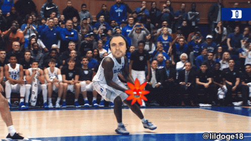 A Duke Basketball Player Stands On The Court With A Crowd Watching GIF