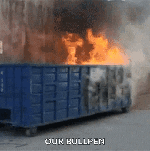 A Dumpster Is On Fire With The Words " Our Bullpen " Above It GIF
