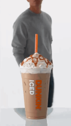 A Dunkin ' Donuts Iced Coffee With Whipped Cream And Caramel Sauce GIF