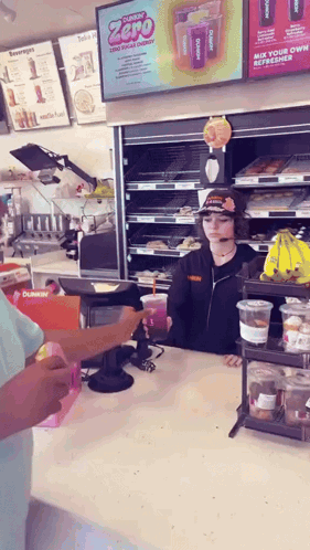 a dunkin ' donuts worker serves a customer