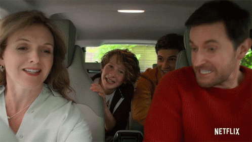 Family Sitting In Car Back Seat With Netflix Logo GIF