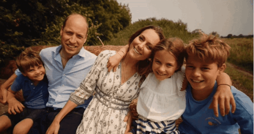 A Family Posing For A Picture With A Boy Wearing A Shirt That Says ' I Love You ' GIF