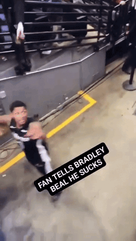 A Fan Tells Bradley Beal He Sucks While A Man Stands In The Background GIF