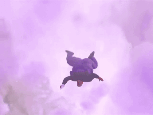A Fat Man In A Purple Shirt Is Flying Through The Air Holding A Wii Remote . GIF