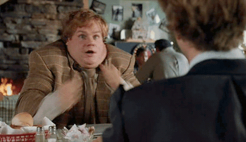 A Fat Man In A Suit And Tie Is Sitting At A Table Talking To Another Man In A Restaurant . GIF