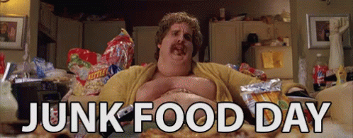 A Fat Man Is Laying On A Couch With Junk Food Day Written In White Letters GIF