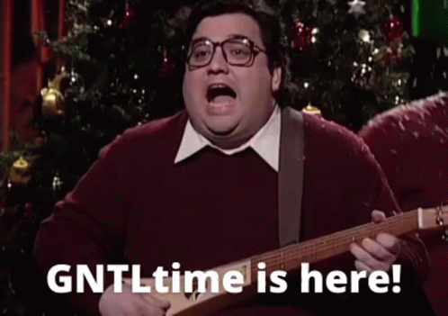 A Fat Man Is Playing A Guitar In Front Of A Christmas Tree And Saying `` Gntl Time Is Here '' . GIF