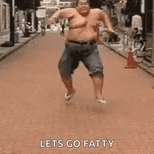 A Fat Man Is Running Down A Street Without A Shirt On . GIF