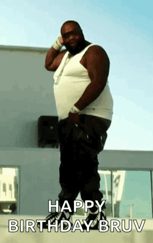 A Fat Man Is Standing In Front Of A Building With The Words Happy Birthday Bruv On The Bottom GIF