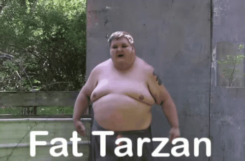 A Fat Man Is Standing In Front Of A Fence With The Words Fat Tarzan Written On It GIF