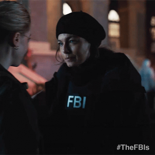 A Fbi Officer Is Talking To Another Woman GIF