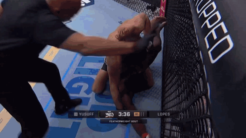 A Featherweight Bout Between Yusuff And Lopes Is Being Shown On A Screen GIF