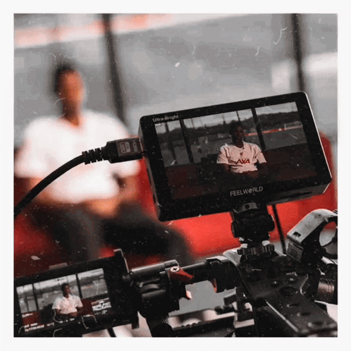 A Feelworld Monitor Shows A Man Sitting In Front Of A Window GIF