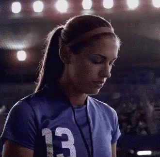 A Female Athlete Wearing A Blue Jersey With The Number 13 On It GIF