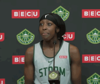 A Female Basketball Player Stands In Front Of A Microphone Wearing A Storm Jersey GIF