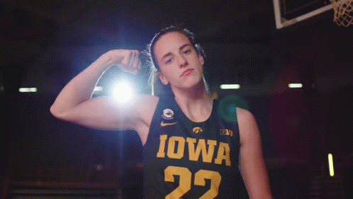 a female basketball player wearing a black jersey with iowa on it