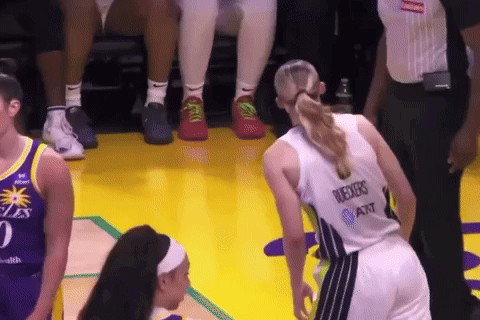 A Female Basketball Player Wearing A Jersey That Says ' Reeves At & T ' On The Back GIF