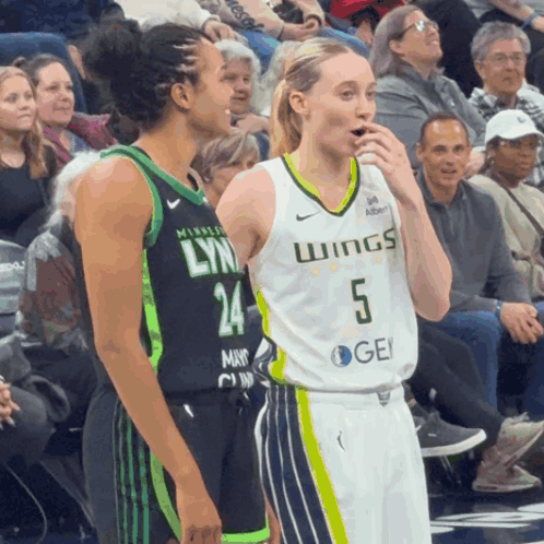 A Female Basketball Player Wearing A Jersey That Says Wings GIF