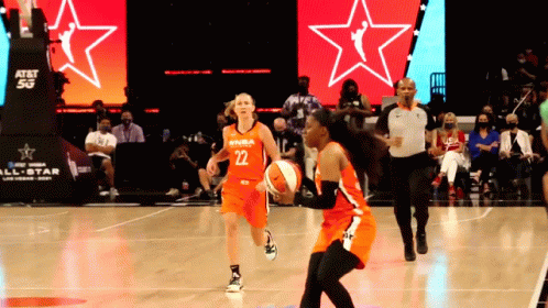 A Female Basketball Player Wearing A Number 22 Jersey Dribbles The Ball GIF