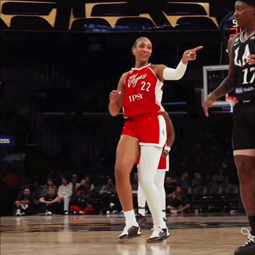 A Female Basketball Player Wearing A Red And White Uniform With The Number 22 On It GIF