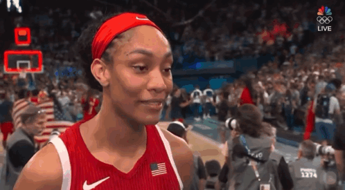 A Female Basketball Player Wearing A Red Nike Jersey And Headband GIF