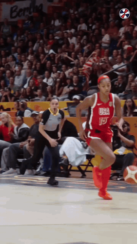 a female basketball player wearing a red usa jersey