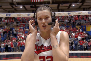 a female basketball player wearing headphones and a jersey with the number 22 on it
