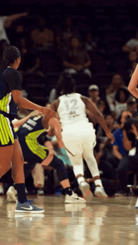 A Female Basketball Player With The Number 12 On Her Jersey GIF