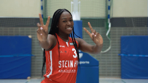 A Female Basketball Player With The Number 3 On Her Jersey Giving A Peace Sign GIF