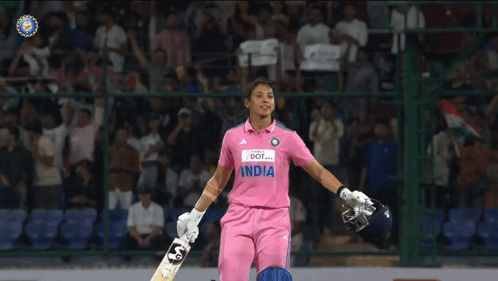 A Female Cricket Player In A Pink India Jersey Holds Her Bat GIF