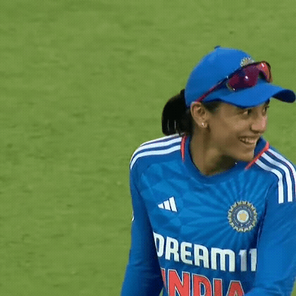 A Female Cricket Player Wearing A Blue Hat And Sunglasses Is Smiling . GIF
