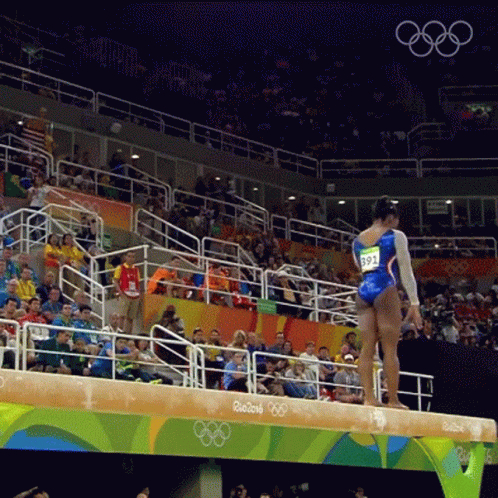 A Female Gymnast Stands On A Balance Beam At The Rio 2016 Olympic Games GIF