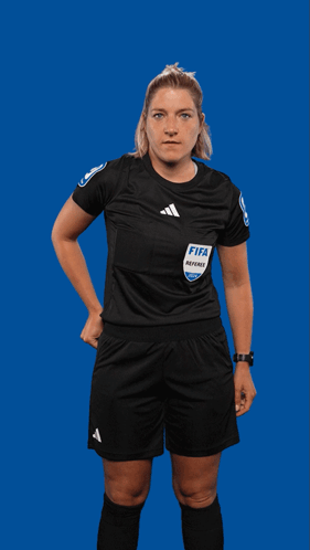 A Female Referee Holds Up A Red Card With The Word Fifa On It GIF