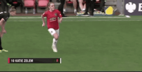 a female soccer player named katie zelen is running on a field