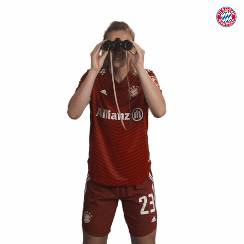 A Female Soccer Player Wearing A Red Allianz Jersey Holds Binoculars GIF