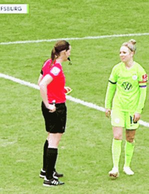 A Female Soccer Player With The Number 10 On Her Shorts Is Talking To A Referee GIF