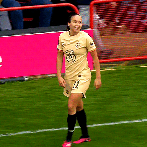 A Female Soccer Player With The Number 11 On Her Shorts Is Smiling GIF