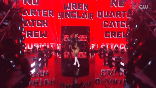 a female wrestler named wren sinclair is standing in front of a red wall