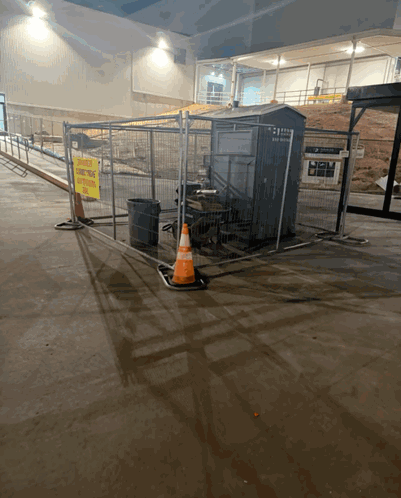 A Fenced In Area With A Yellow Sign That Says " No Smoking " GIF