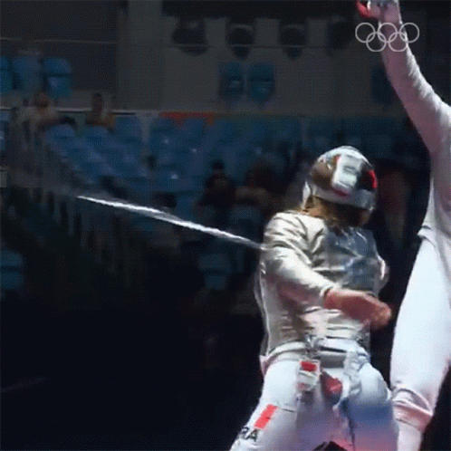 A Fencer Wearing A Helmet And Pants With The Letter Ra On Them GIF