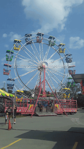 a ferris wheel at a carnival with people riding it