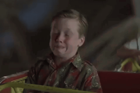 A Ferris Wheel Is Lit Up At Night GIF